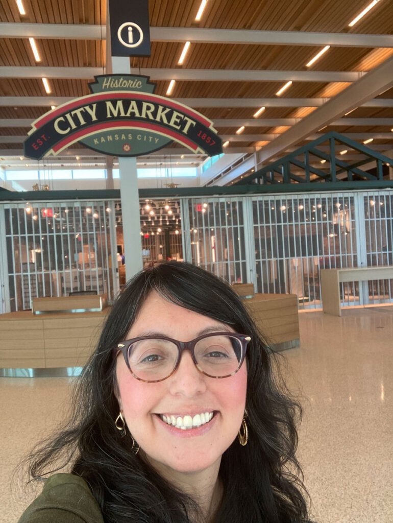 Lucia taking a selfie in front of Kansas City Airport