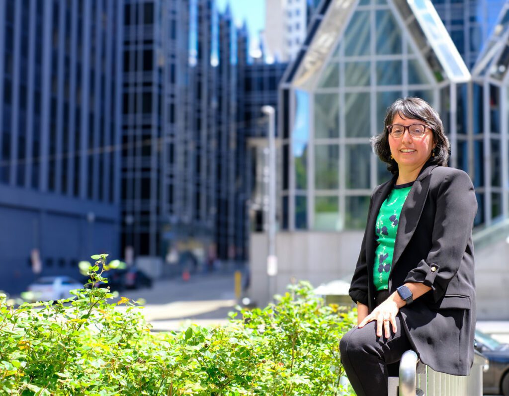 Architect poses behind PPG place with some greenery