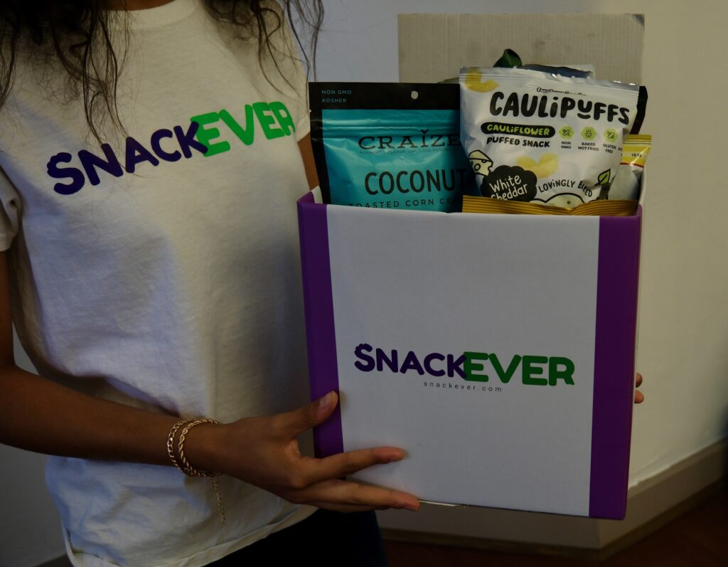 Snackever subscriber box filled with caulipuffs and other snacks.