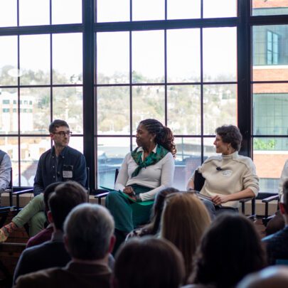 A group of 5 panelists sit by a window in our office.