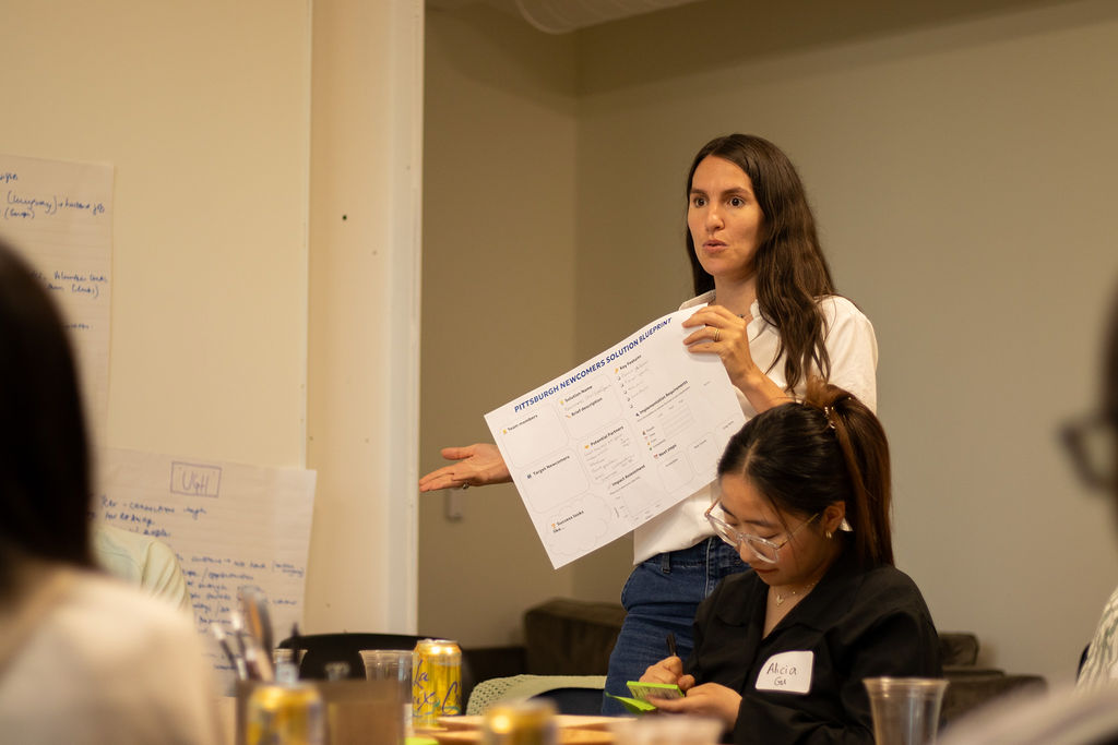 A woman presents her group's idea