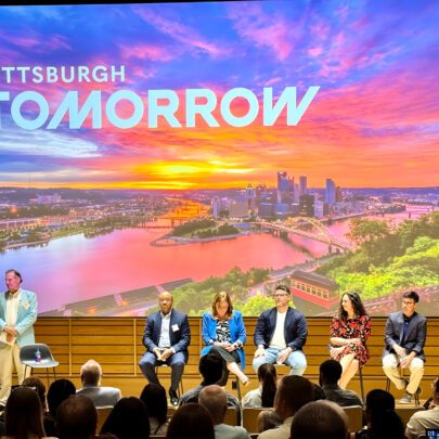 A panel with a sunset image of Pittsburgh in the background.