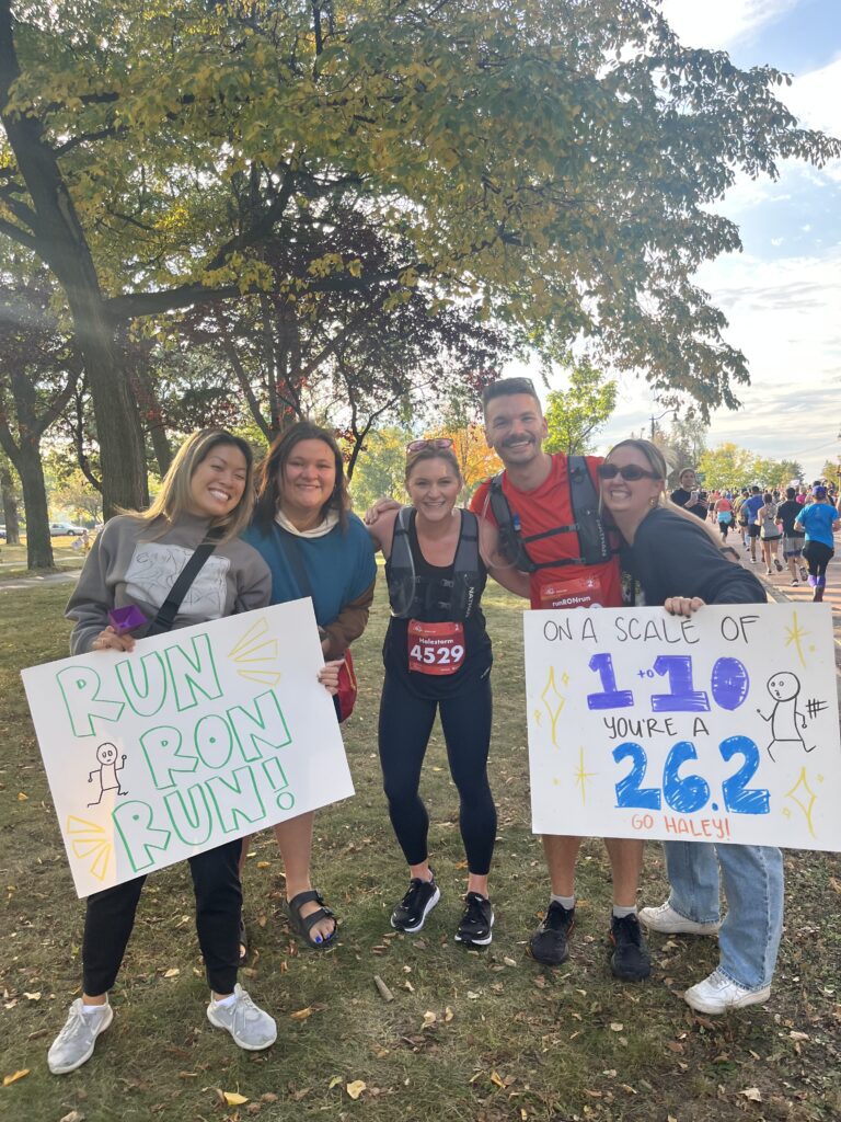 Haley is standing with friends after running a marathon.
