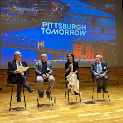 Four panelists on stage giving a talk
