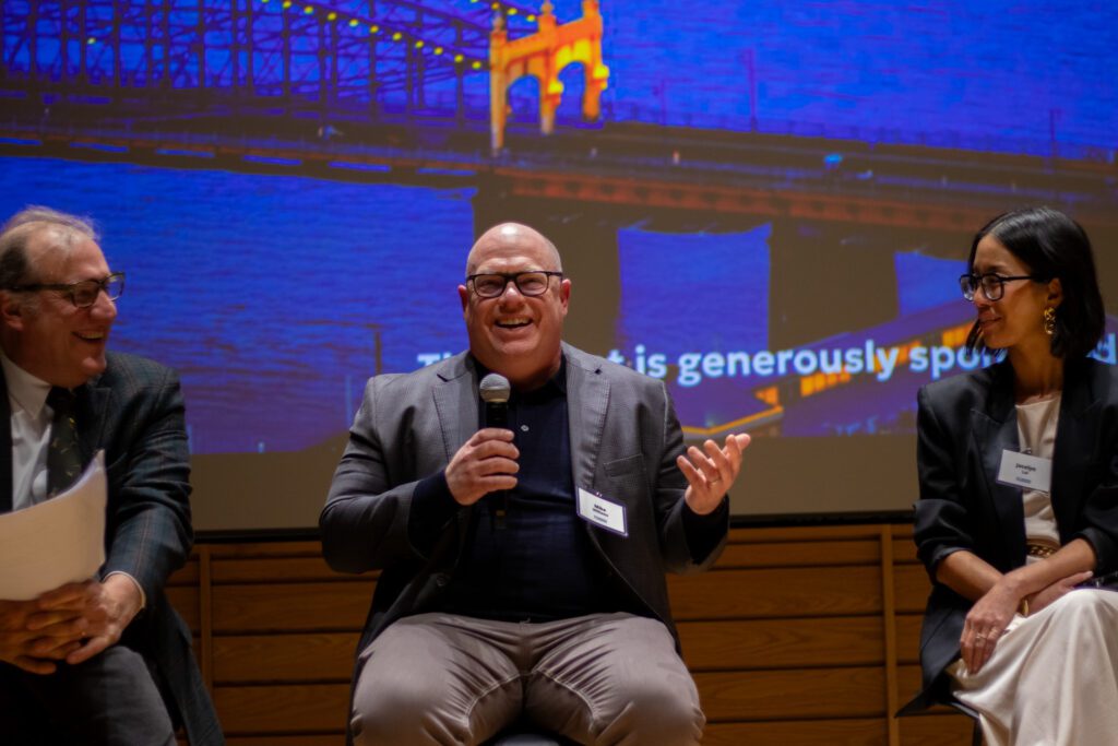 Mike Williams smiles as he makes a point on stage