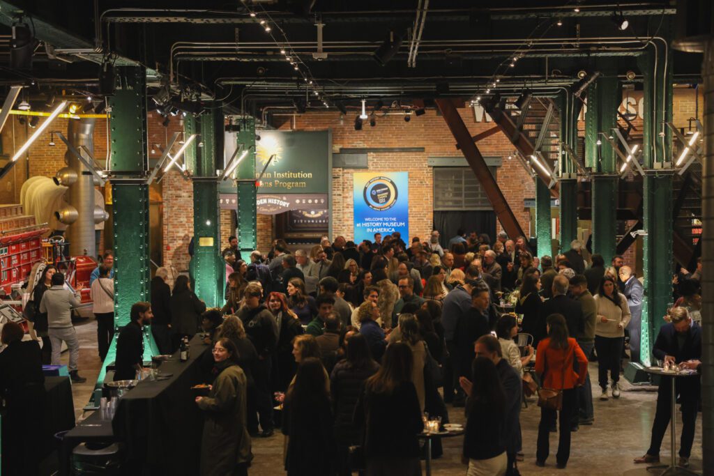 A large gathering fills the Heinz History Center. 